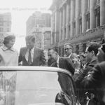 Kennedy Ticker Tape Parade, Whitehall & Broadway to City Hall. Jackie and John F. Kennedy riding in tickertape parade. To the right is Paul Screvane, Commissioner of Sanitation. October 19, 1960.